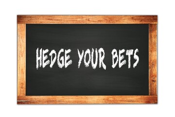 HEDGE  YOUR  BETS text written on wooden frame school blackboard.