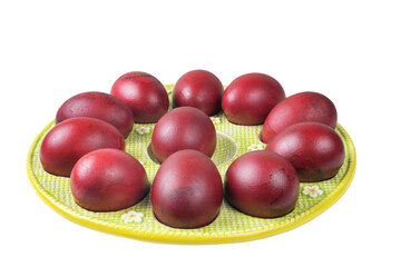 A plate of colored red Easter eggs isolated on a white background