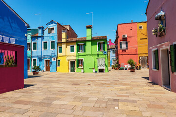 Old small beautiful colorful houses with bright colors in Burano island in a sunny spring day. Venetian lagoon, Venice, UNESCO world heritage site, Veneto, Italy, southern Europe.