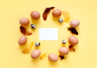Happy Easter flat lay composition. Easter eggs decorated feathers on background. Flat lay, top view. Copy space.