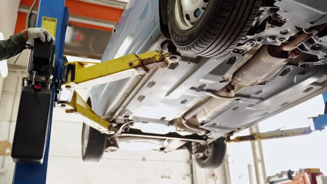 the car is lifted on a car lift in a car service. bottom view.