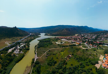 Aerial view of streets of Mtskheta village in Georgia with Mtkvari river. View of the city from the...