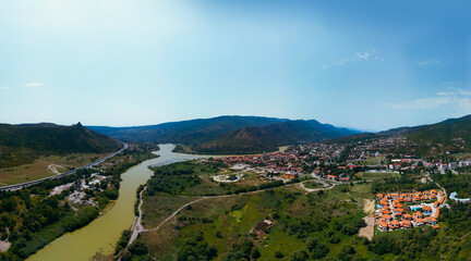 Aerial view of River side streets of Mtskheta village in Georgia with Mtkvari river. View of the city from the north, from Tsitsamuri