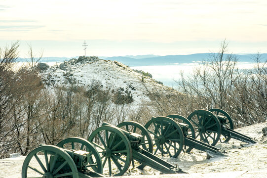 Artillery from old metal cannons. Cannon in the battles at Shipka. Winter, snow, panorama and clouds in the background.