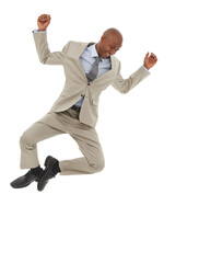 Floating on success. An African-American businessman jumping joyfully in the air.