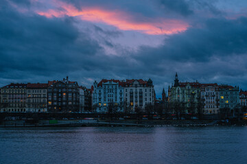 Fototapeta premium Dreamy Prague panorama with Vltava river at sunset with beautifully painted pink sky, Czech Republic.