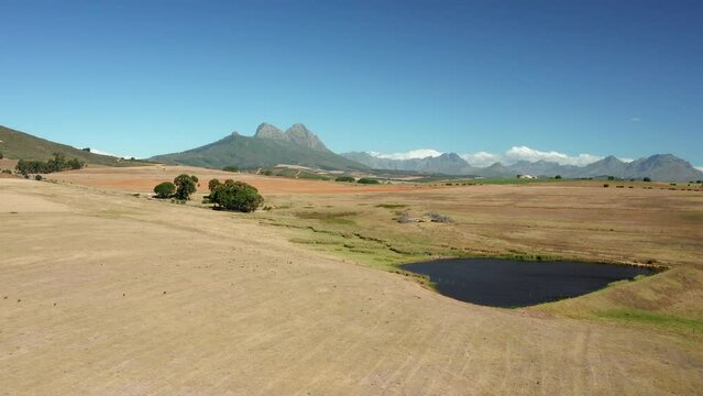 Isolated Pond Amidst Wilderness Of Simonsberg Nature Reserve Near Wine Region In Stellenbosch, Western Cape Province Of South Africa. Aerial Drone Shot
