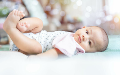 Adorable, Asian newborn lying on bed. Baby boy looking camera and smile happy face. Little innocent new infant child in first day of life. Mother day concept.