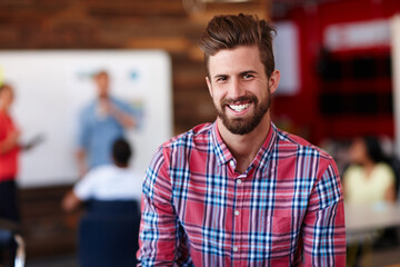 Obraz premium Hes the office go-getter. Portrait of a young male designer in a casual work environment.