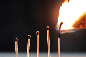 Five matches on a black background. Growth chart of an employee at work before emotional or physical burnout.