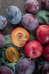 Fresh plums on a dark background