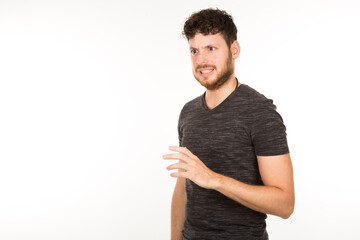 portrait of a young Caucasian man with beard and a rejecting gesture on white background