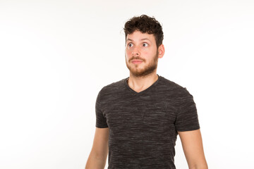 young bearded man with surprised expression on white background