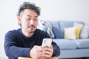 Portrait of a bearded man looking at a cell phone Cell phone Copy space available