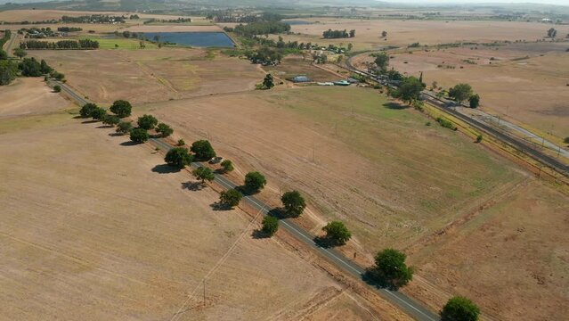 Aerial Shot Of Car Driving Across The Road On Simonsberg Nature Reserve Near Wine Estate In Stellenbosch, Western Cape Province Of South Africa.