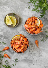 Red cooked prawn or shrimp with lemon on a gray background. Top view