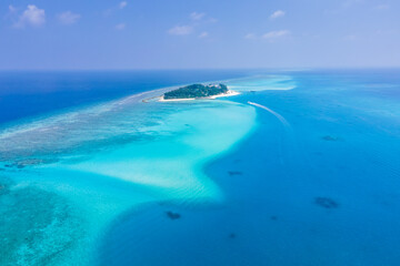 Naklejka na ściany i meble Atoll island with white sand beach, turquoise transparent water, coral reef, blue sky. Perfect tropical vacation holidays destination in Maldives. Aerial view from seaplane.
