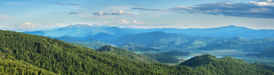 Mountain landscape, evening light, valley and peaks in a blue haze, panoramic view