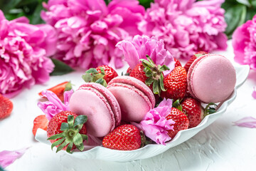 pink macaron or macaroon cakes with peony rose on a white background. Banner, flyer, beautiful postcard, top view