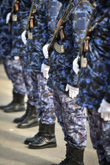 Fototapeta na wymiar Soldiers in camouflage uniforms are seen in formation during military ceremony