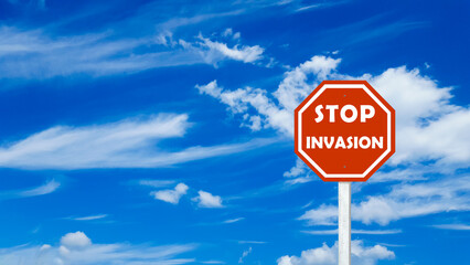 Red sign with text stop invasion on blue cloudy sky background
