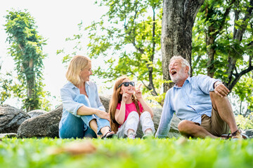Fototapeta premium Happy family parent and child relax in weekend holiday lifestyle park outdoor nature background.