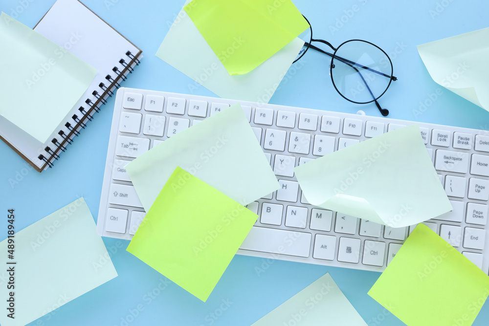 Poster many ideas. busy work schedule. flat lay of the workplace. white keyboard. a lot of sticky note pape