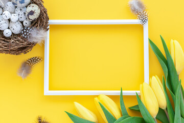 Easter holiday background with quail nest and photo frame