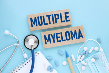 Multiple Myeloma. text on wooden blocks on a blue background. stethoscope pills medicine concept