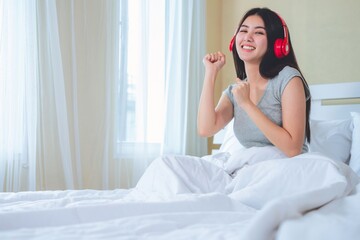 Asian women happy to listen to music.