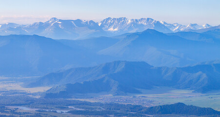 Obraz na płótnie Canvas Mountains in blue haze. Morning light, valley and mountainsides.