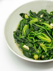 A plate of garlic fried spinach,