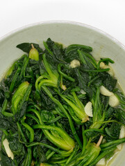 A plate of garlic fried spinach,