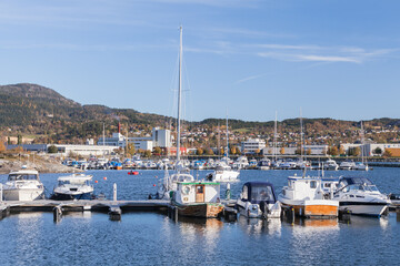 Fototapeta na wymiar Yachts and motor boats are moored in Norwegian harbor