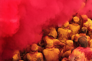 People throw colours to each other during the Holi celebration in Uttar Pradesh, India. Holi is the most celebrated festival in India - obrazy, fototapety, plakaty