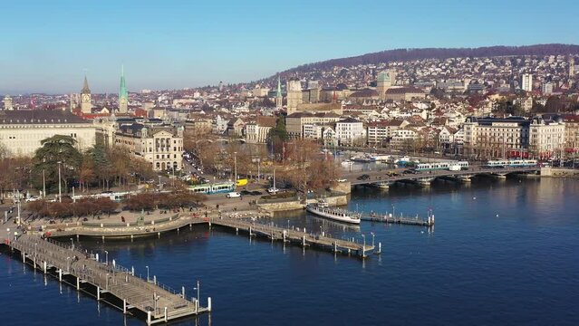 Aerial drone footage of the Guisanquay in Zurich downtown waterfront on a sunny winter day in Switzerland. Shot with a forward tilt down motion. 