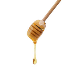 Dripping with bee juice. Shot of a honey dipper dripping delicious honey.