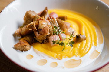 Pumpkin puree with ham and croutons. Menu design concept for a restaurant.