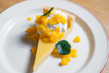 Cheesecake garnished with peach slices. A light dessert from a restaurant.