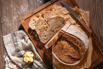 Freshly artisan baked wheat and rye bread, country bread. Simple bread  with butter for breackfast