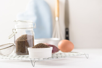 Organic perilla seeds in a ceramic bowl on white background. Natural products, healthy baking ingredients