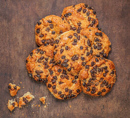 Chocolate cookies  on dark wooden table. Brown Chocolate chip cookies top view.