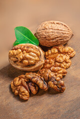  Fresh walnut  with green leaves on  wooden background. Copyspace