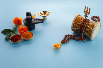 Happy Maha Shivaratri greeting card - Shiva Linga decorated with flowers, trishula, damru and bilva...