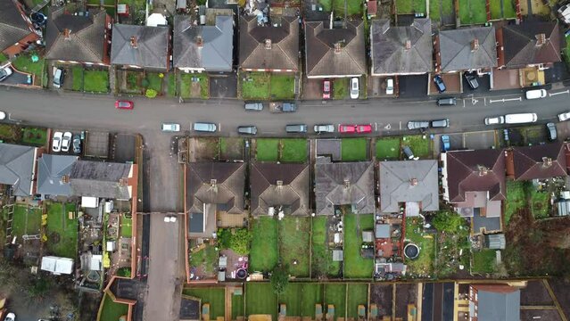 Dull aerial top down view of a British council estate of low cost homes and gardens