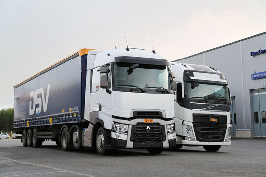 Renault Trucks T and Volvo FH Semi Trailer Trucks on a Yard. 