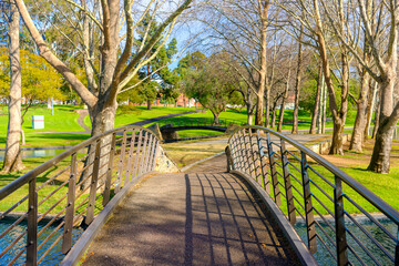 Bridge over the pond at Rymill Park  in Adelaide city on a sunny winter day. The park has been Adelaide's families favourite since the 1960s