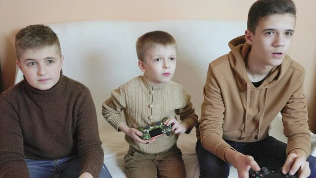 children playing on the console with joysticks in ruhs close-up