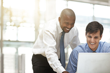 This is some great work. Cropped shot of two businessmen discussing work in the office.