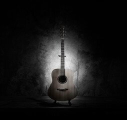 Obraz na płótnie Canvas acoustic guitar instrument musical retro style. Material Face Wood Solid Spruce, Mahogany Body. Art photography. Isolated on wall cement background.